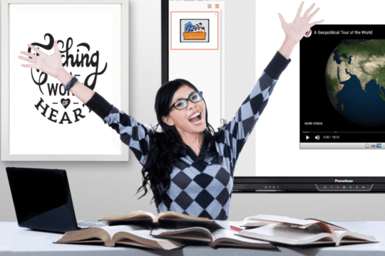 Teacher excited in the classroom with books on her desk