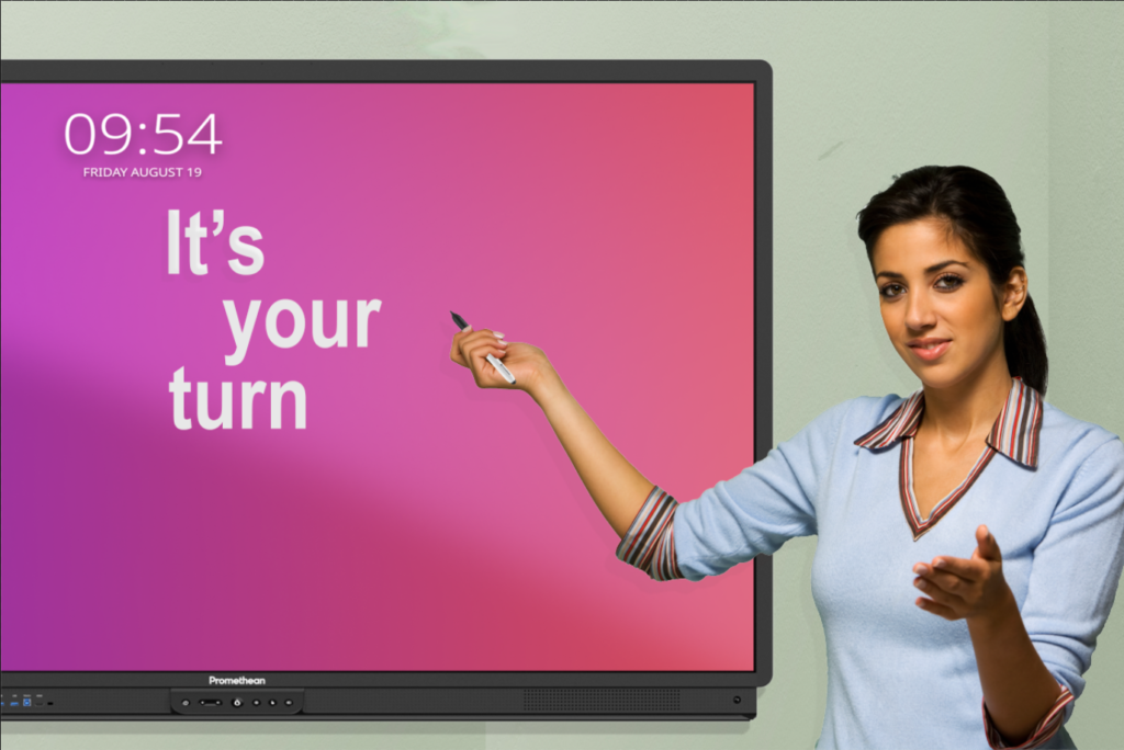 Teacher in front of ActivPanel pointing to It's your turn