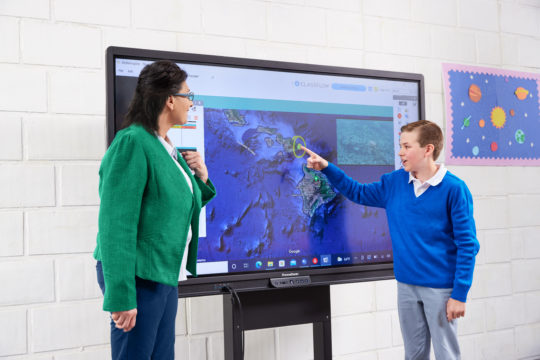 This is an image of a student and teaching collaborating on the Promethean ActivPanel.