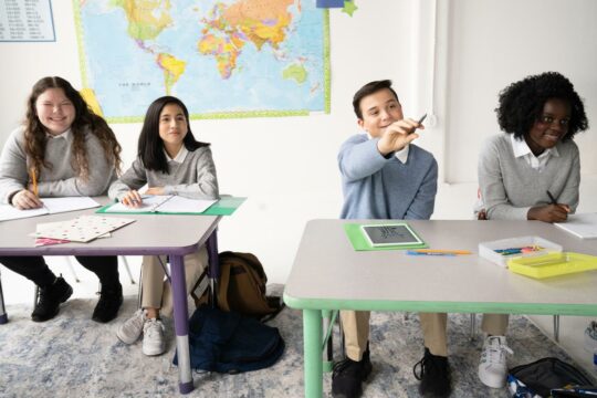 This image depicts students in a classroom engaging in a lesson.
